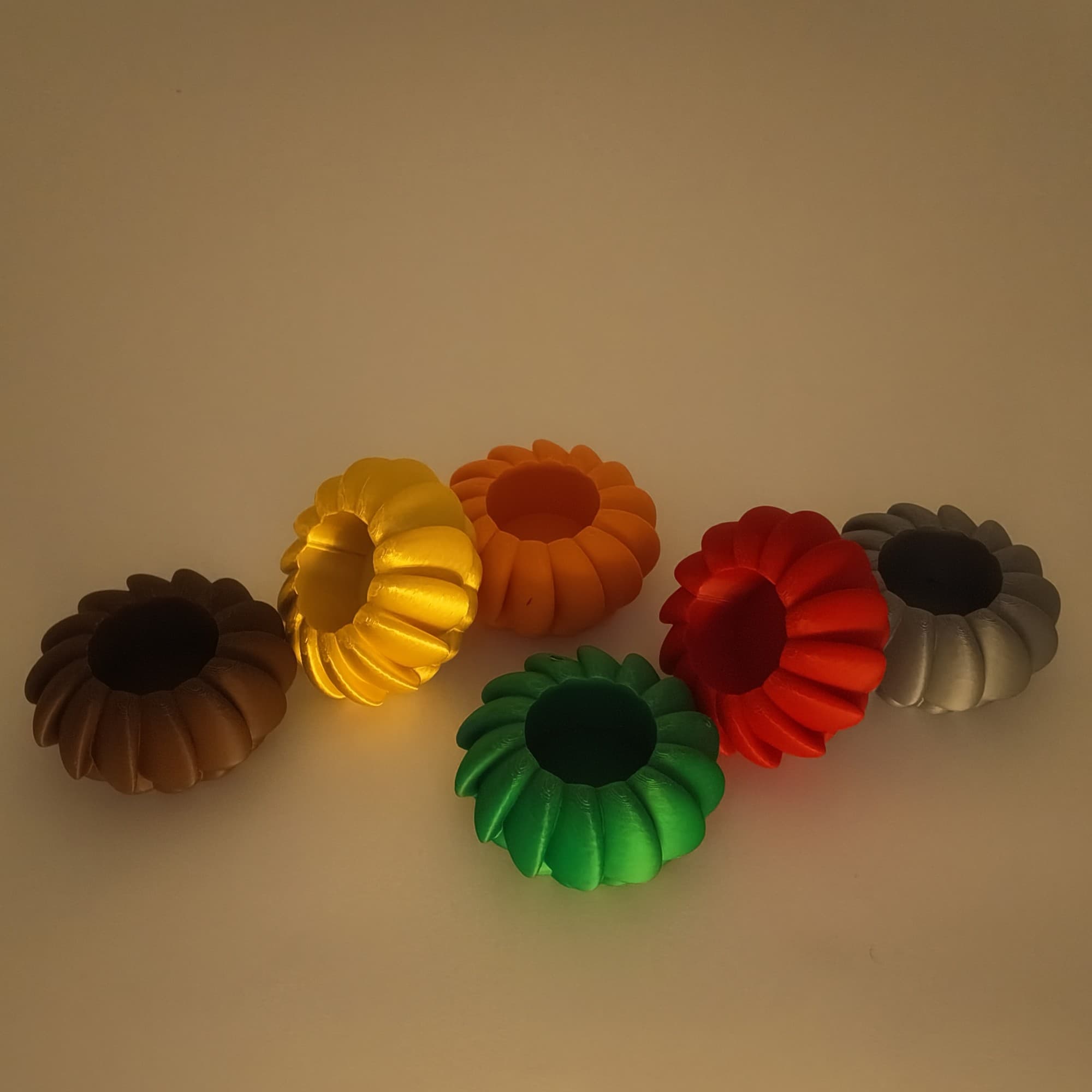 The six PetalGlow holders unlit in soft light